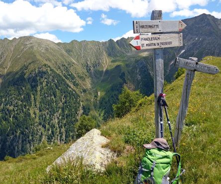 Hirzer Passiria Valley with signpost and green backpack 