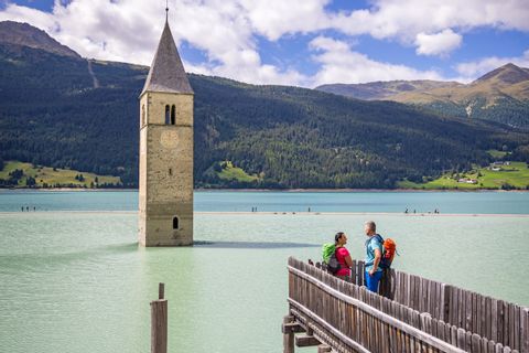 Beautiful view of the church tower in Steg on Lake Reschen