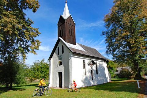 Cyclist in front of small church