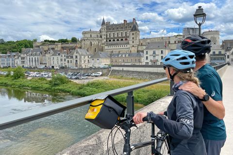Couple of cyclists View of Amboise Castle