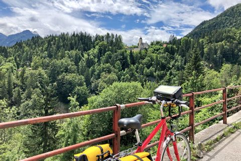 Cycle break with a view of a church in the forest