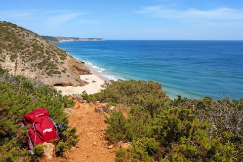 Hiking backpack in front of hiking panorama in algarve bay