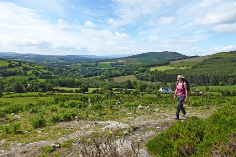 Hiker marvels the lush green landscape of Ireland
