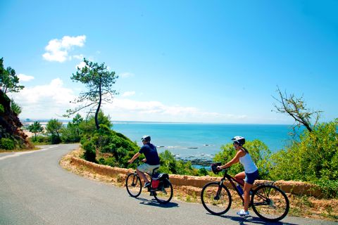 Cyclists enjoy lonely coastal road on the Atlantic Ocean