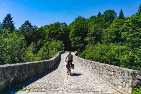biker on a stone bridge