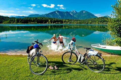 Cyclists splashing in a lake